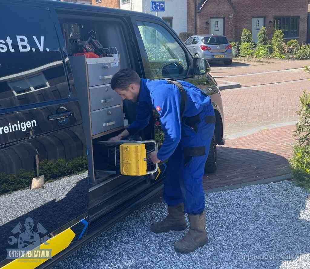 Een monteur pakt apparatuur uit de bedrijfsbus voor service aan huis, het moment om een professional in te schakelen voor een verstopte wc in Katwijk